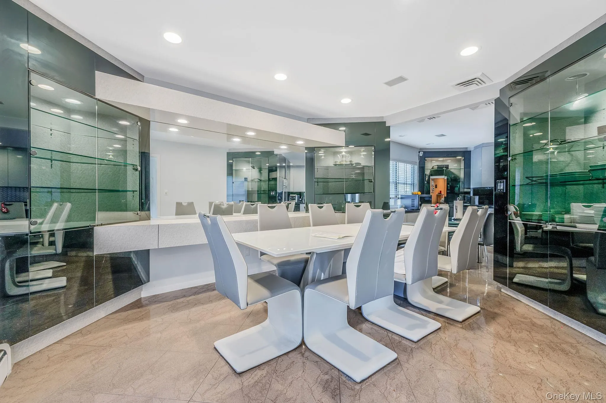 Dining area with recessed lighting and light marble finish flooring Dining area with recessed lighting and light marble finish flooring