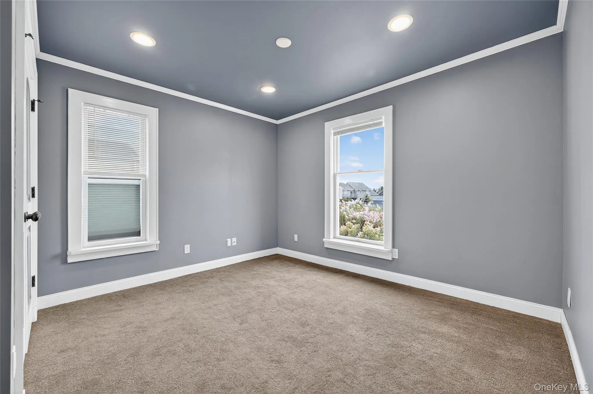 Carpeted bedroom with ornamental molding, plenty of natural light, and recessed lighting Carpeted bedroom with ornamental molding, plenty of natural light, and recessed lighting