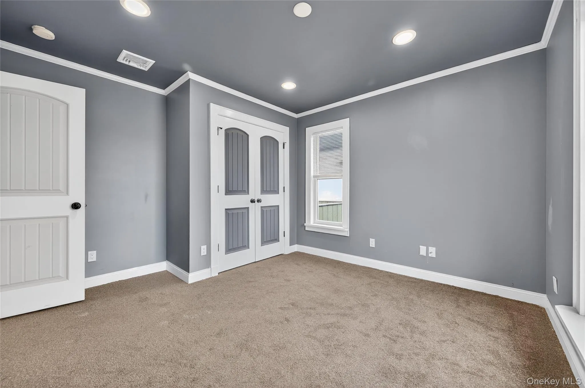 Bedroom with crown molding, carpet floors, and recessed lighting Bedroom with crown molding, carpet floors, and recessed lighting