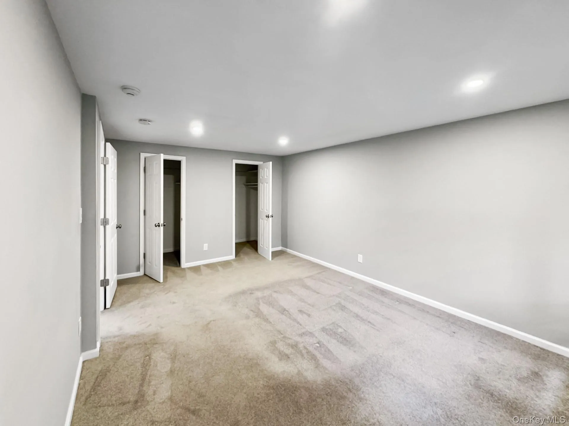 Unfurnished bedroom featuring carpet floors, a walk in closet, and recessed lighting Unfurnished bedroom featuring carpet floors, a walk in closet, and recessed lighting