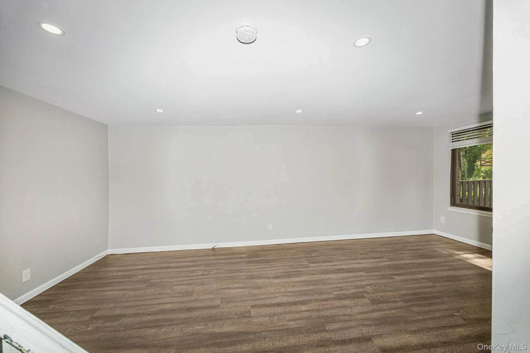 Unfurnished room featuring dark wood-style floors and recessed lighting Unfurnished room featuring dark wood-style floors and recessed lighting