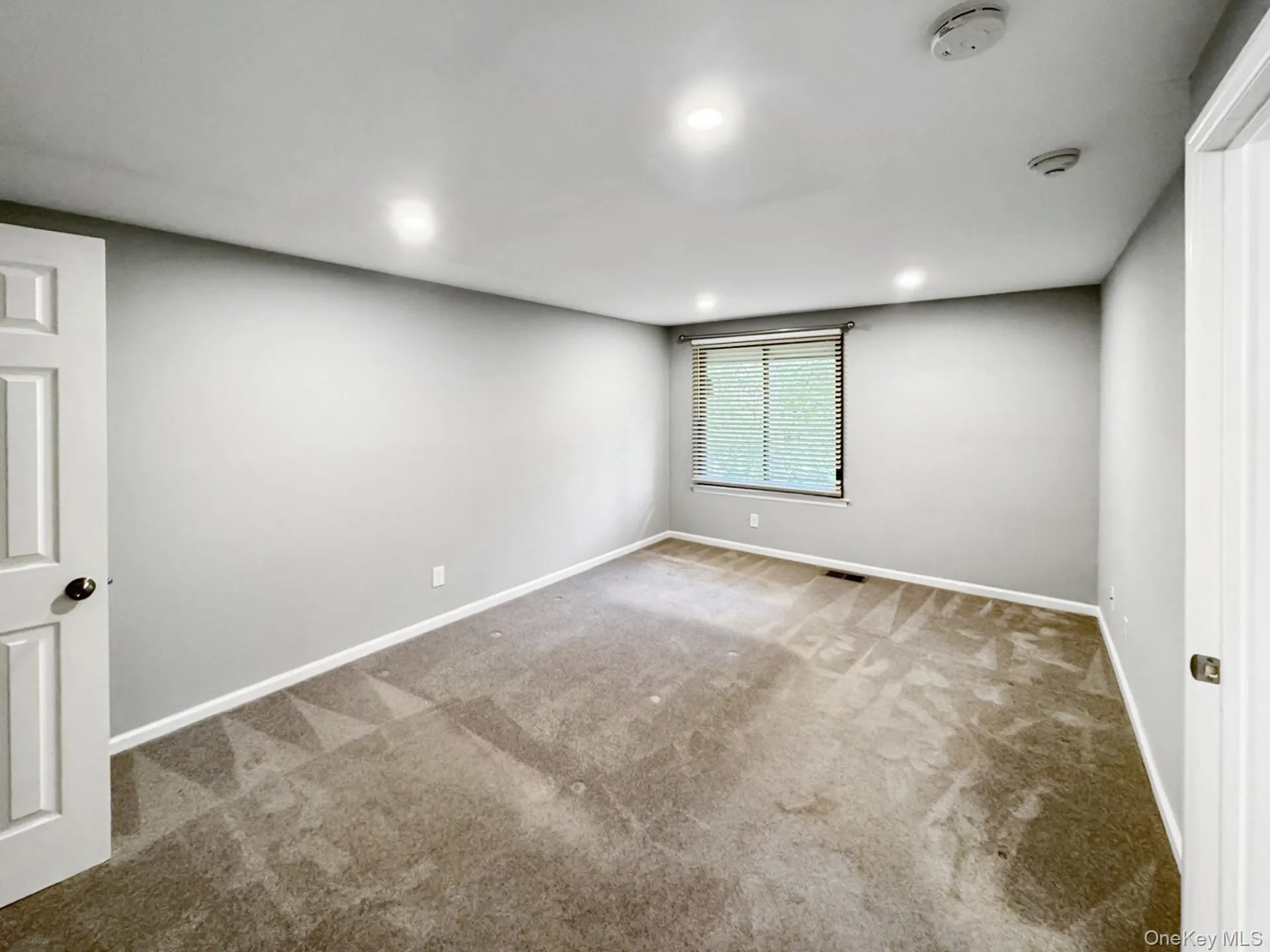 Carpeted spare room with baseboards and recessed lighting Carpeted spare room with baseboards and recessed lighting