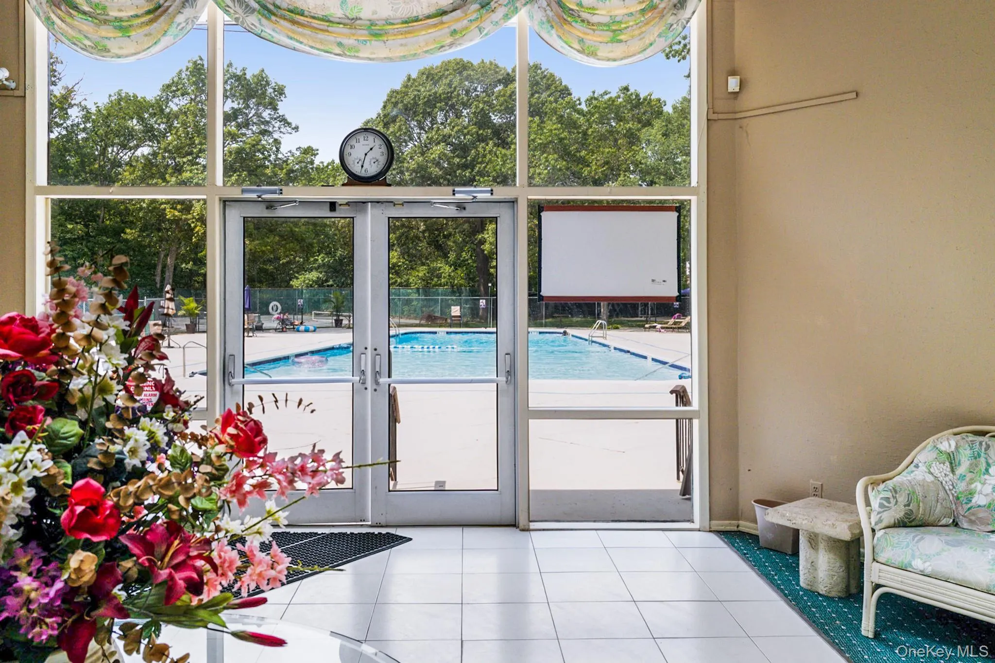 View of swimming pool featuring a sunroom View of swimming pool featuring a sunroom