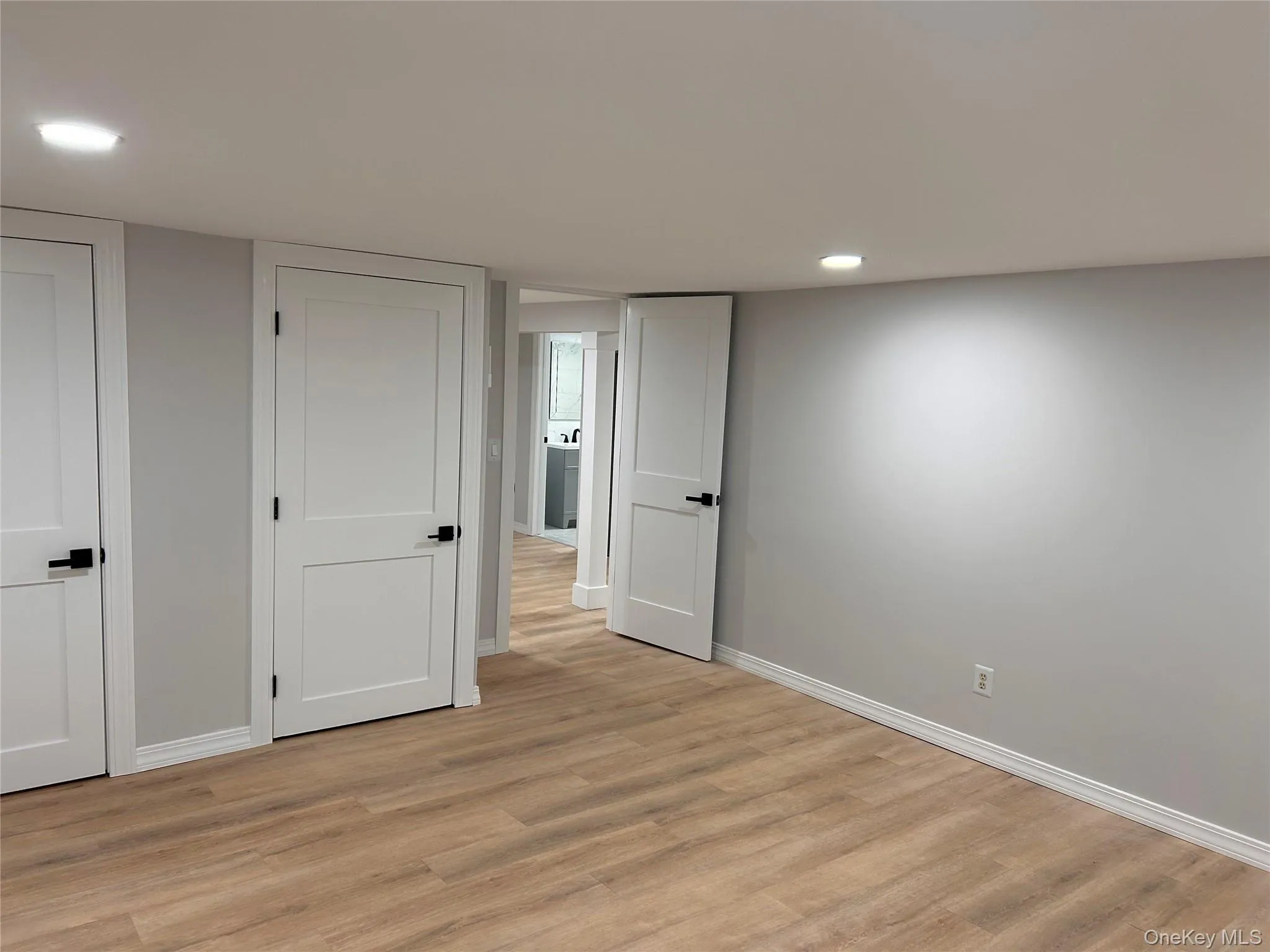 Unfurnished bedroom with light wood-type flooring and recessed lighting Unfurnished bedroom with light wood-type flooring and recessed lighting