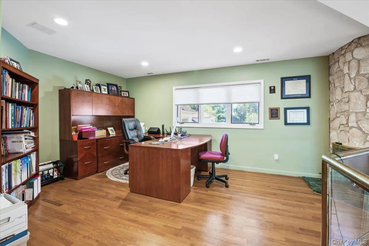 Home office with light wood finished floors and recessed lighting Home office with light wood finished floors and recessed lighting