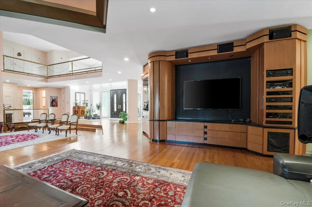 Living room with light wood-style flooring and recessed lighting Living room with light wood-style flooring and recessed lighting
