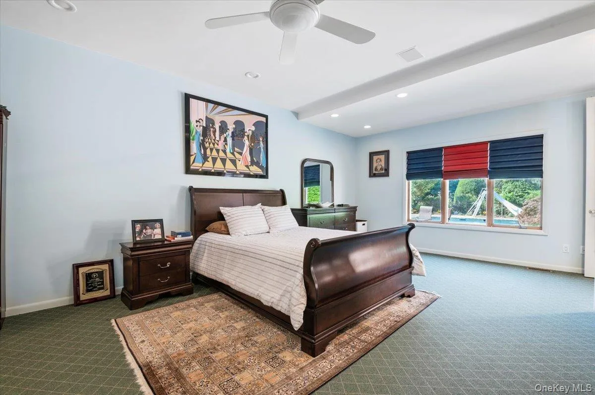Carpeted bedroom featuring recessed lighting and a ceiling fan Carpeted bedroom featuring recessed lighting and a ceiling fan