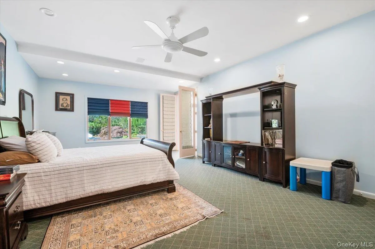 Carpeted bedroom featuring recessed lighting and a ceiling fan Carpeted bedroom featuring recessed lighting and a ceiling fan
