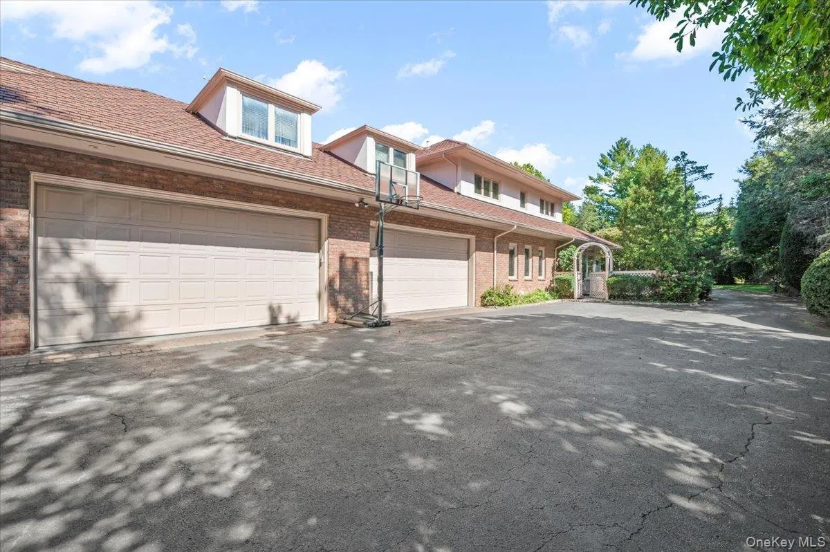 View of front facade featuring asphalt driveway and brick siding View of front facade featuring asphalt driveway and brick siding