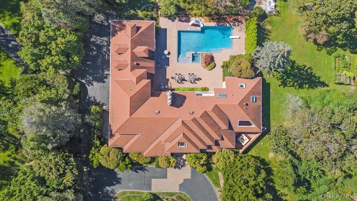 Drone / aerial view of a pool area and a tree filled landscape Drone / aerial view of a pool area and a tree filled landscape