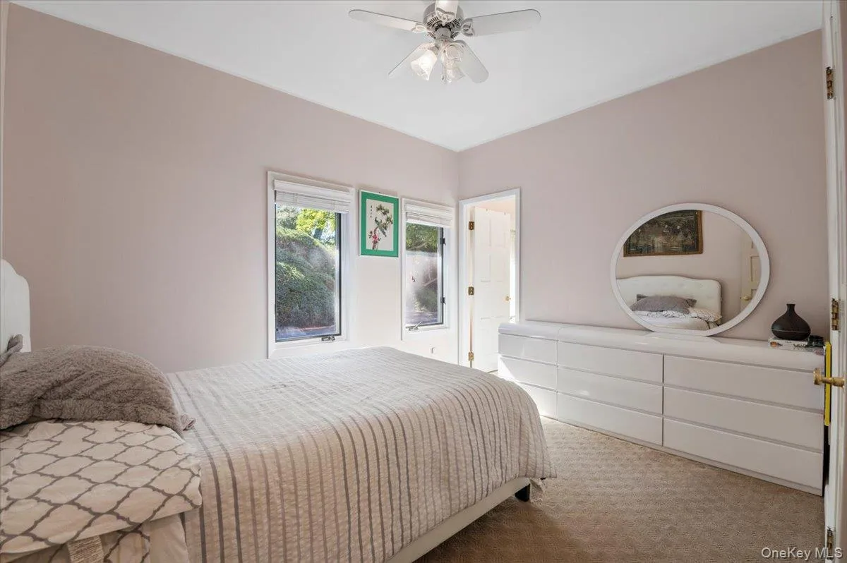 Carpeted bedroom featuring ceiling fan Carpeted bedroom featuring ceiling fan