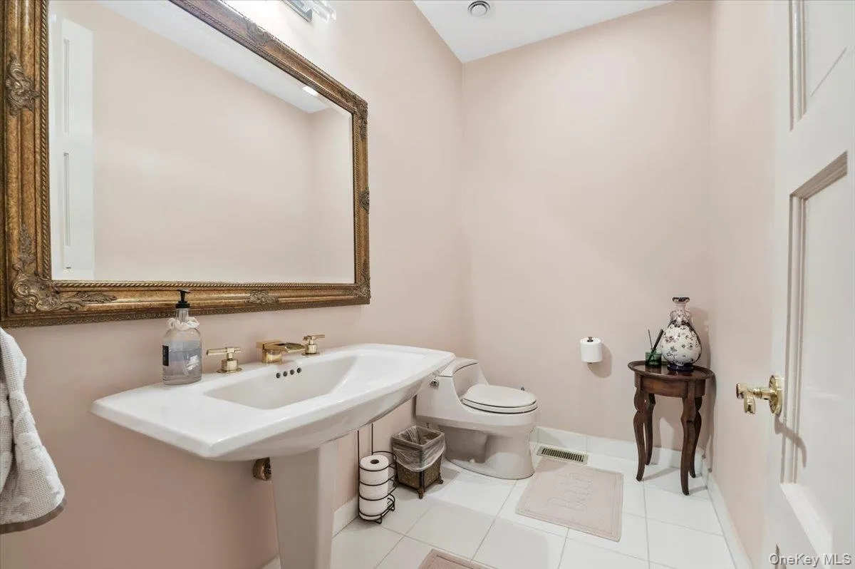 Half bath featuring tile patterned flooring Half bath featuring tile patterned flooring