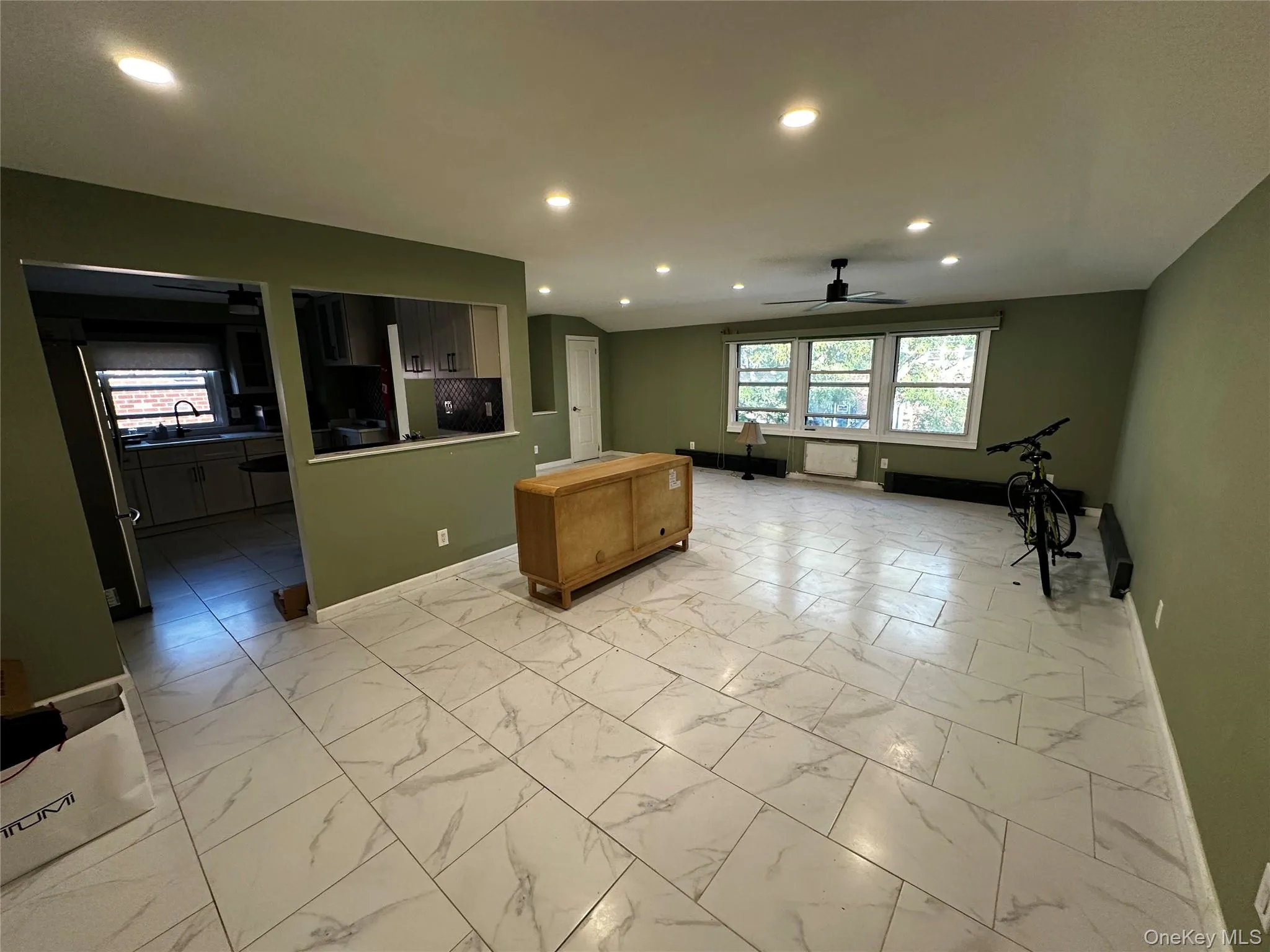 Kitchen featuring light marble finish flooring, a ceiling fan, a center island, recessed lighting, and freestanding refrigerator Kitchen featuring light marble finish flooring, a ceiling fan, a center island, recessed lighting, and freestanding refrigerator