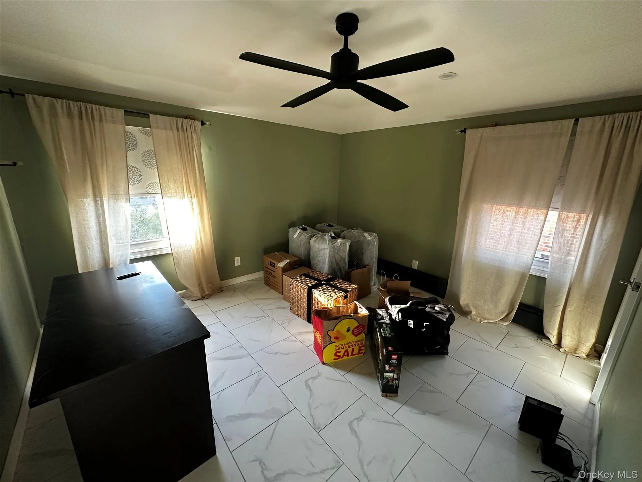 Bedroom with light marble finish floors and ceiling fan Bedroom with light marble finish floors and ceiling fan