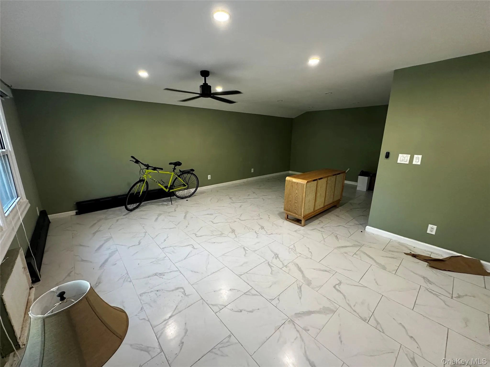 Unfurnished living room featuring light marble finish flooring, a ceiling fan, and recessed lighting Unfurnished living room featuring light marble finish flooring, a ceiling fan, and recessed lighting