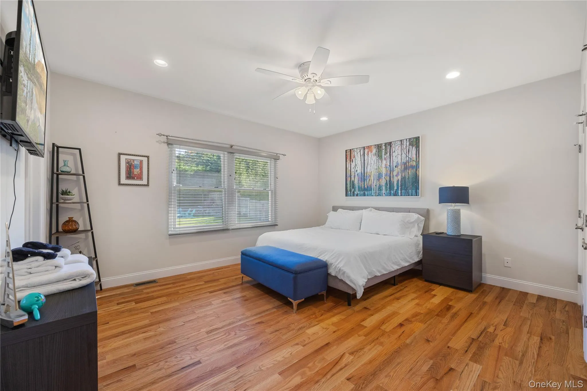 Bedroom featuring light wood finished floors, recessed lighting, and ceiling fan Bedroom featuring light wood finished floors, recessed lighting, and ceiling fan