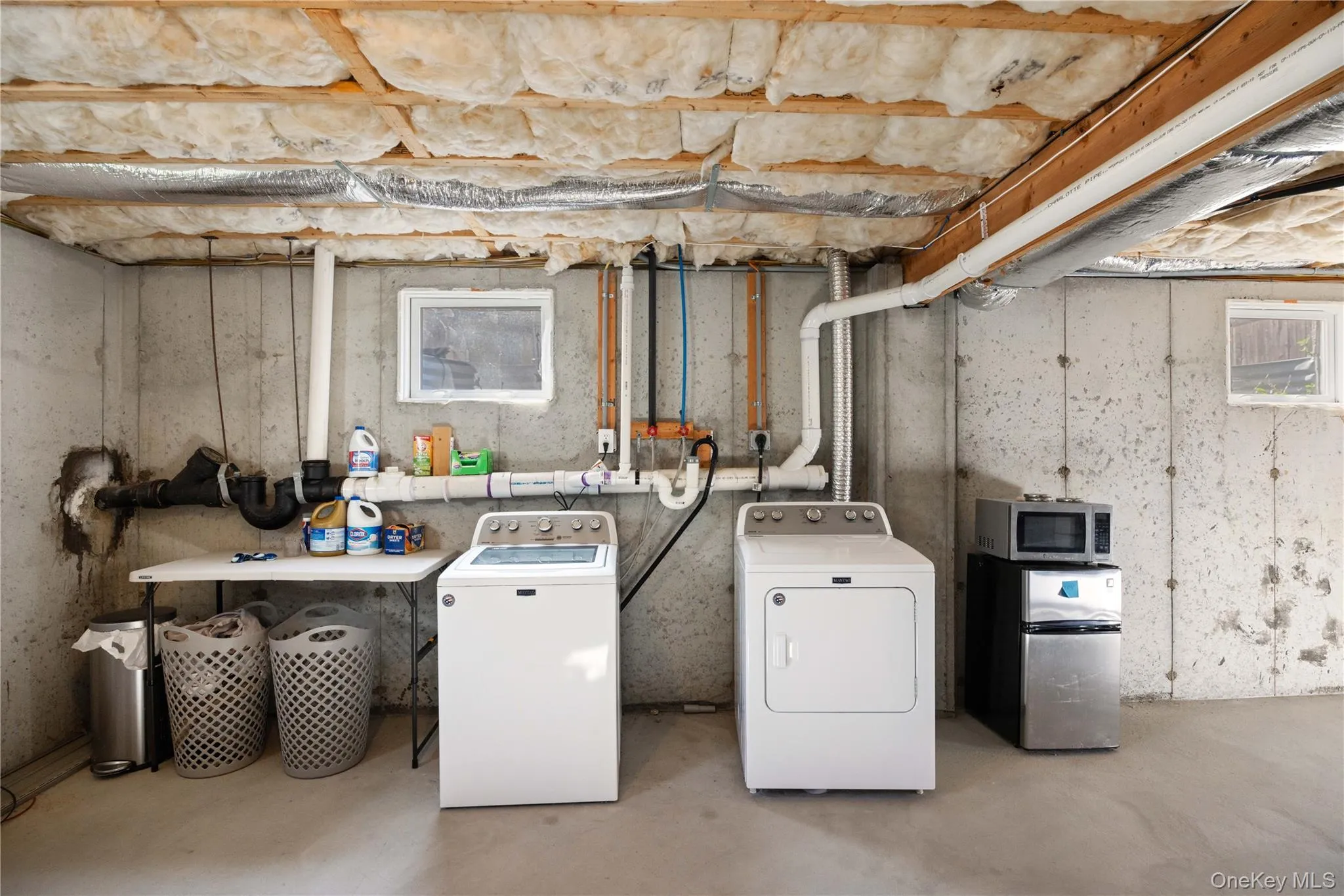 Washroom with separate washer and dryer and concrete floors Washroom with separate washer and dryer and concrete floors