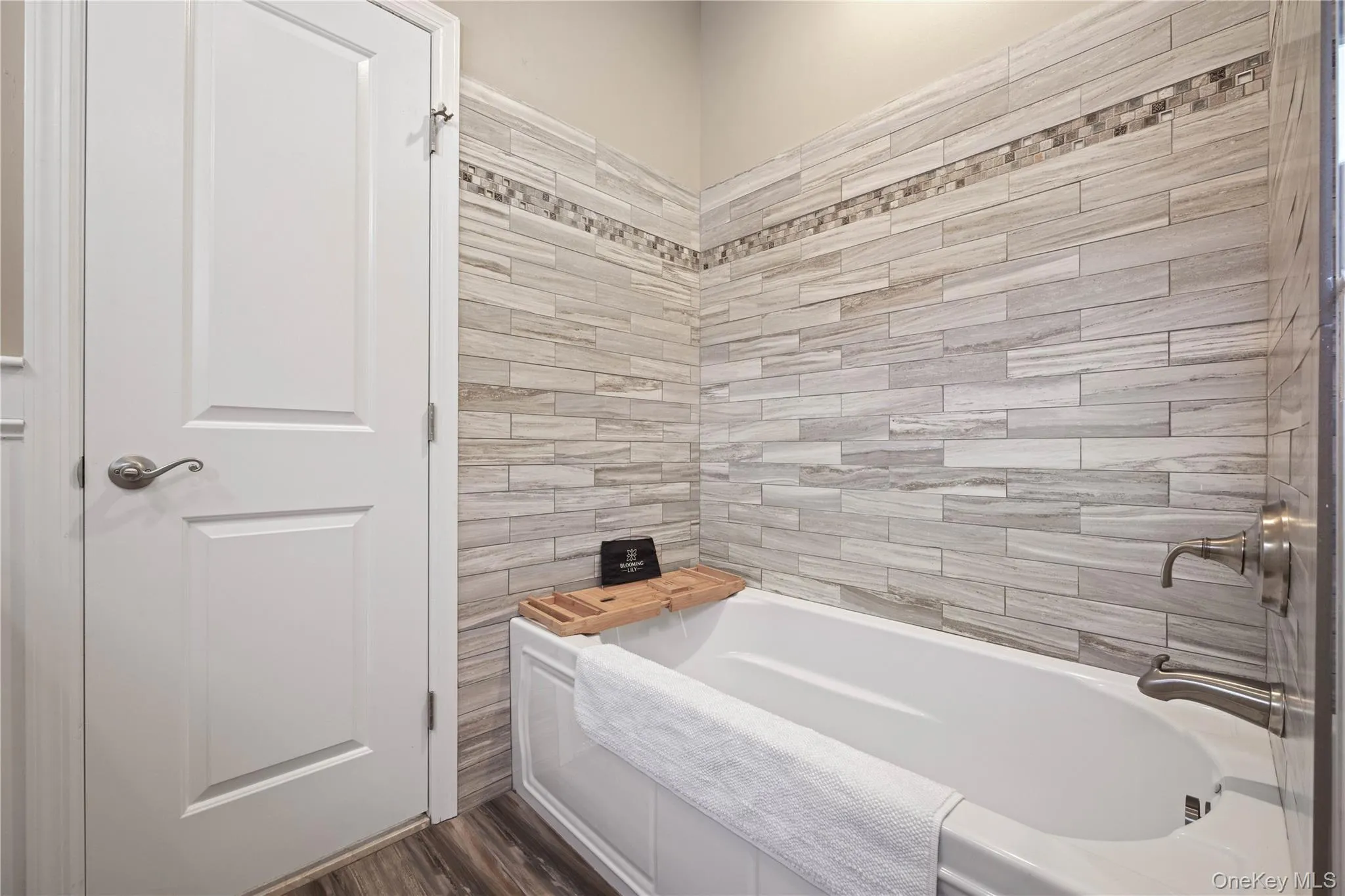 Bathroom featuring a garden tub and dark wood finished floors Bathroom featuring a garden tub and dark wood finished floors