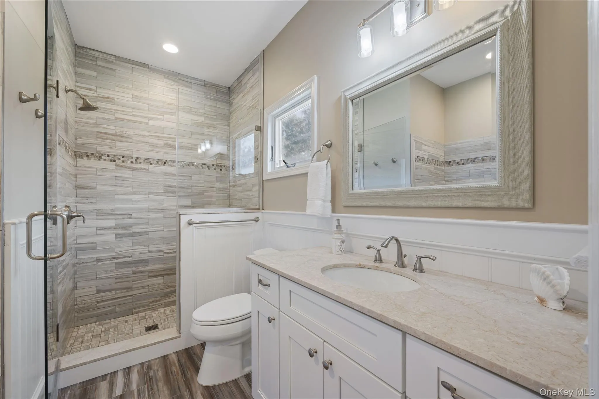 Bathroom featuring vanity, a stall shower, dark wood finished floors, and recessed lighting Bathroom featuring vanity, a stall shower, dark wood finished floors, and recessed lighting