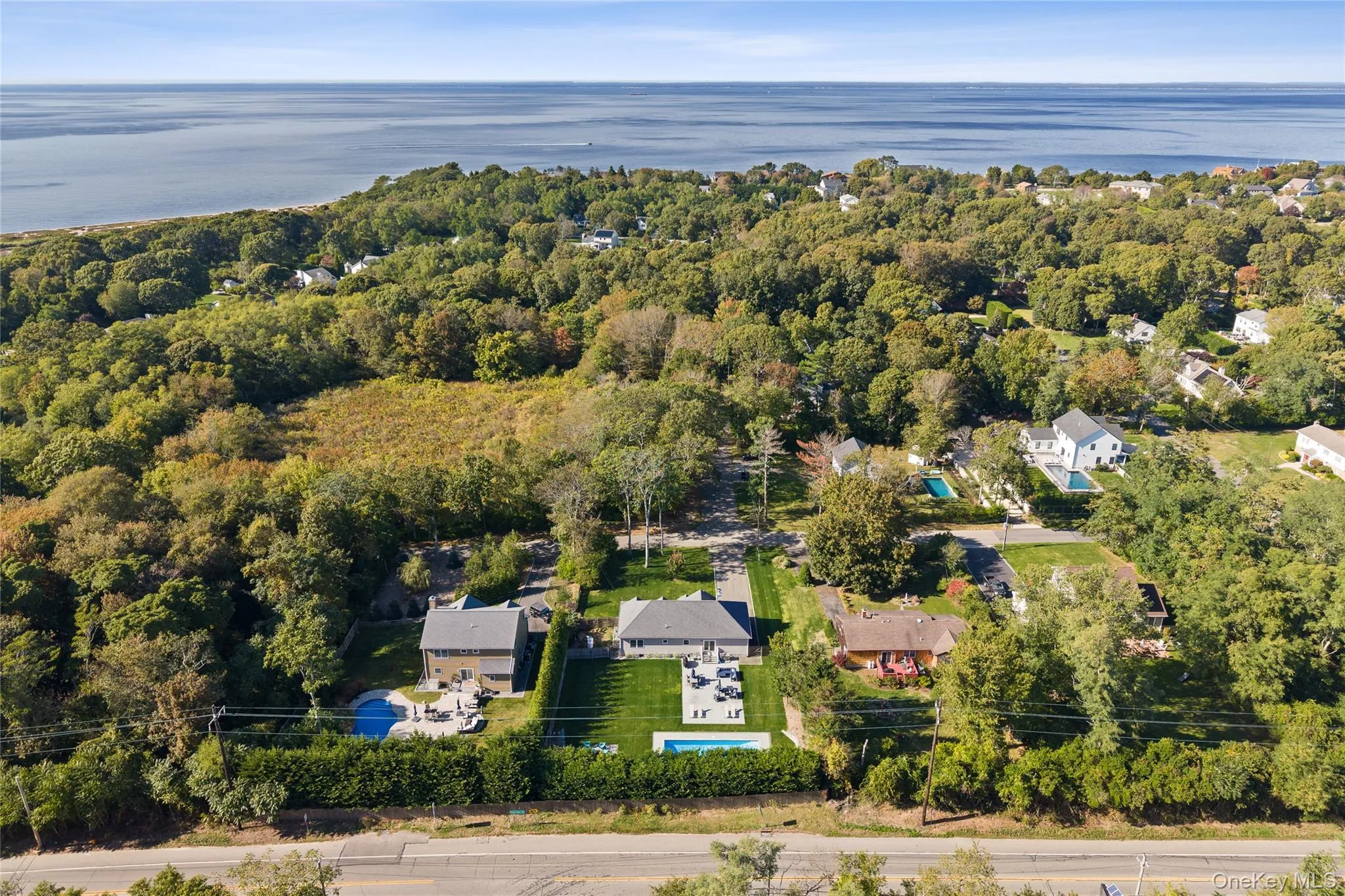 Aerial view of property and surrounding area with a nearby body of water Aerial view of property and surrounding area with a nearby body of water