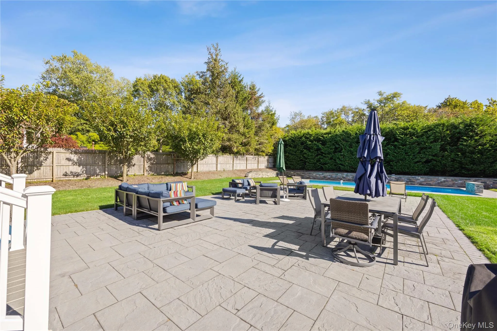 Fenced backyard with an outdoor living space, a patio, and outdoor dining area Fenced backyard with an outdoor living space, a patio, and outdoor dining area