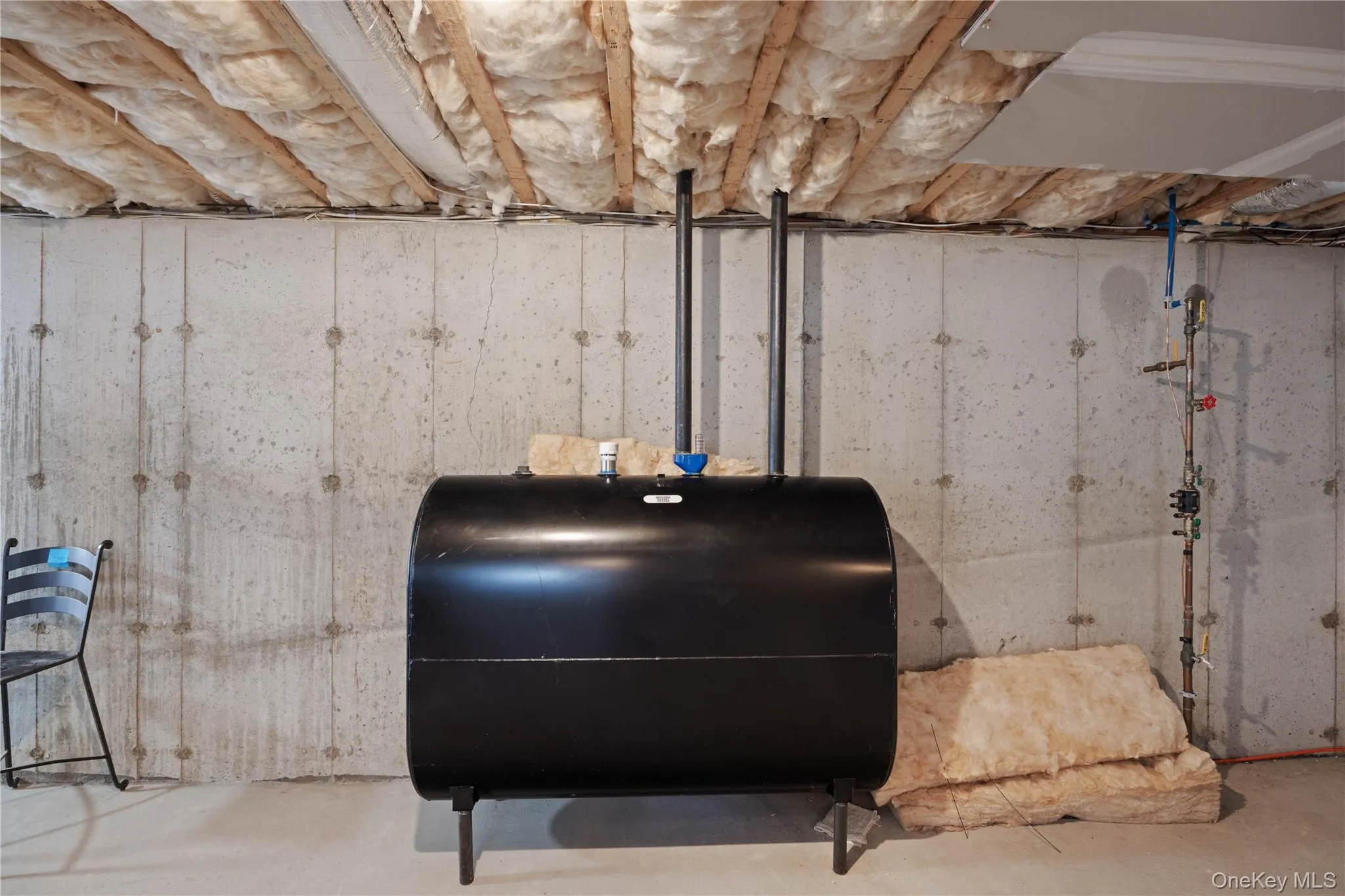 Basement view of concrete flooring and heating fuel Basement view of concrete flooring and heating fuel