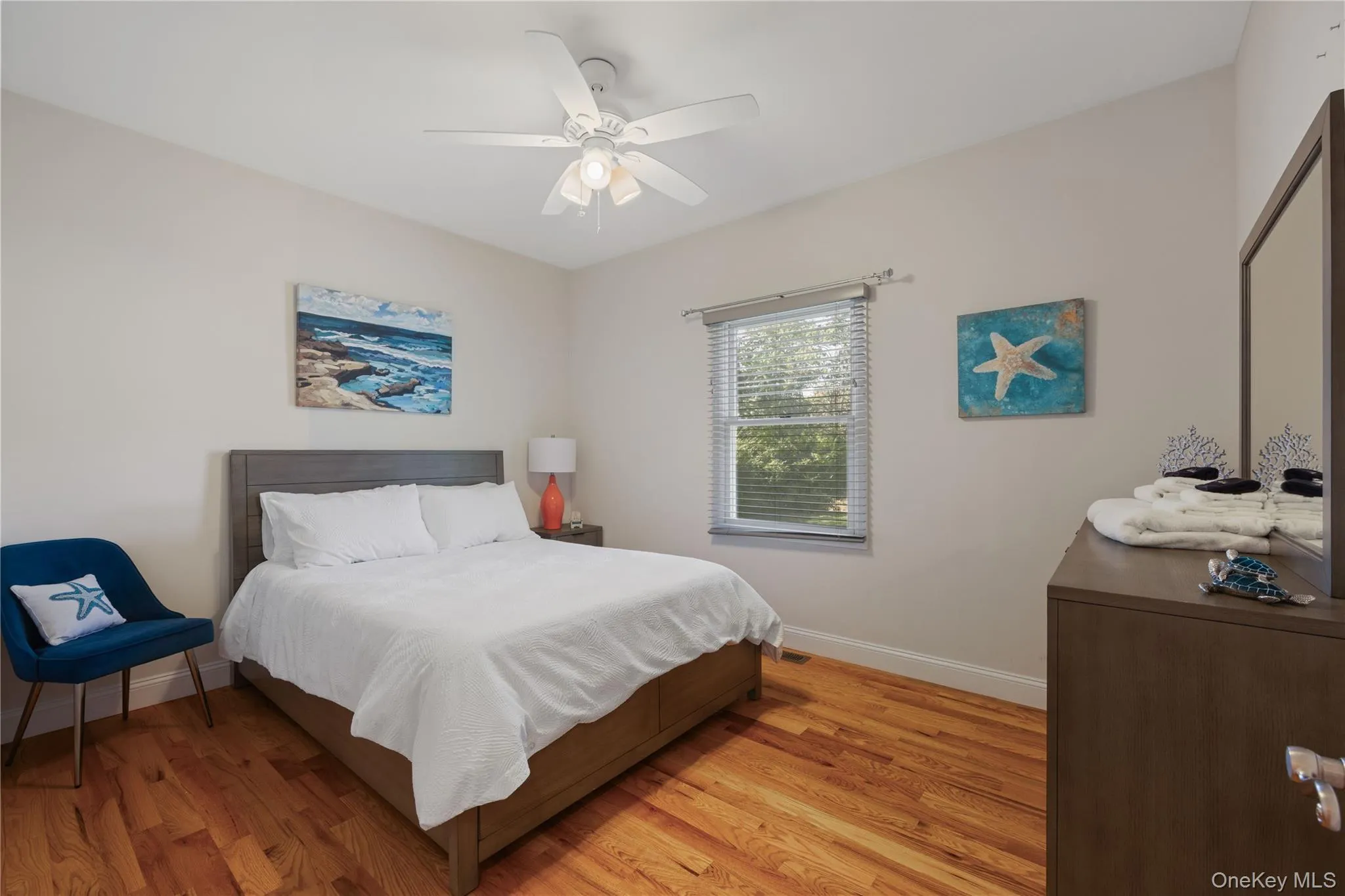 Bedroom with light wood-type flooring and ceiling fan Bedroom with light wood-type flooring and ceiling fan