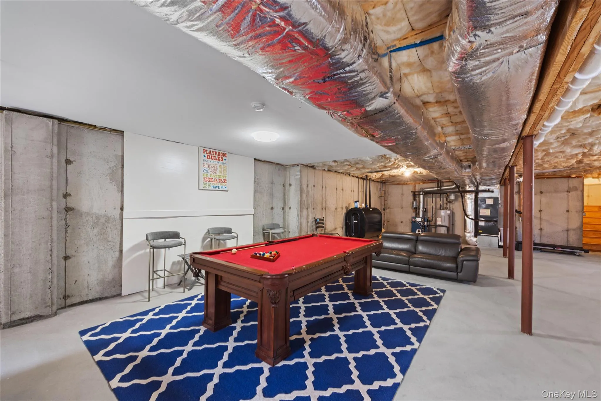 Rec room featuring billiards table, concrete floors, heating fuel, and water heater Rec room featuring billiards table, concrete floors, heating fuel, and water heater