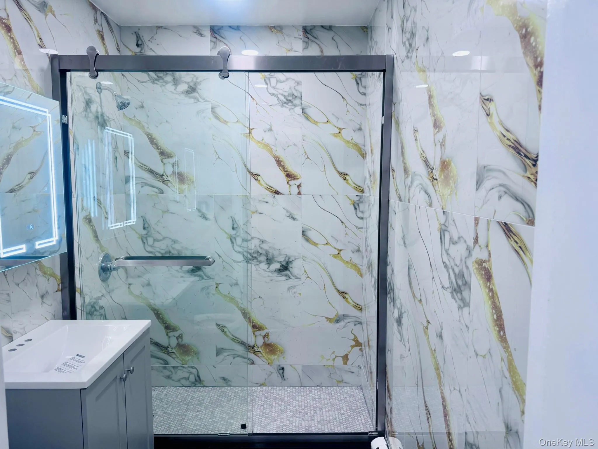 Full bathroom with vanity and a marble finish shower Full bathroom with vanity and a marble finish shower