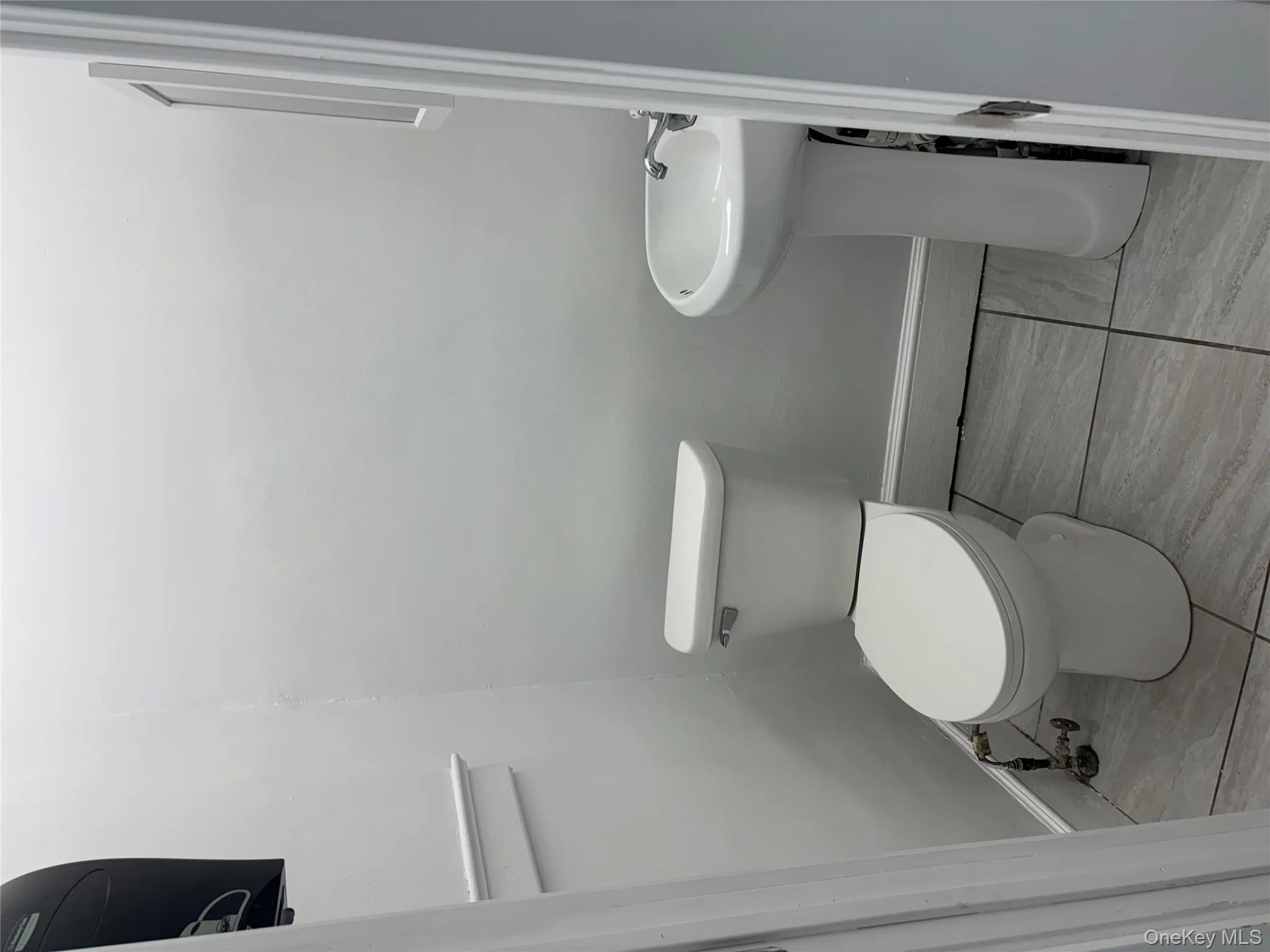 Half bath featuring toilet and baseboards Half bath featuring toilet and baseboards