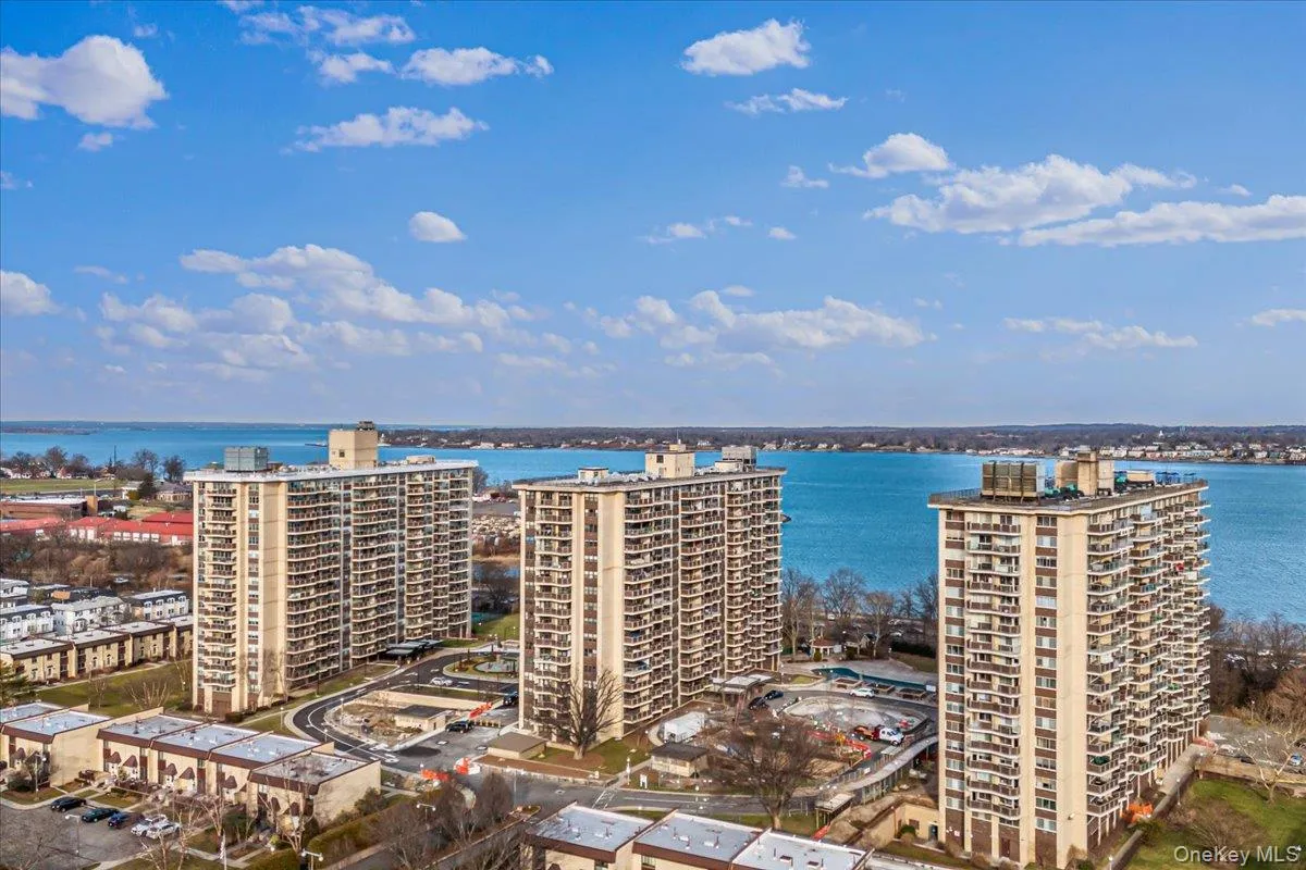 View of urban area with apartment complex / building and a nearby body of water View of urban area with apartment complex / building and a nearby body of water