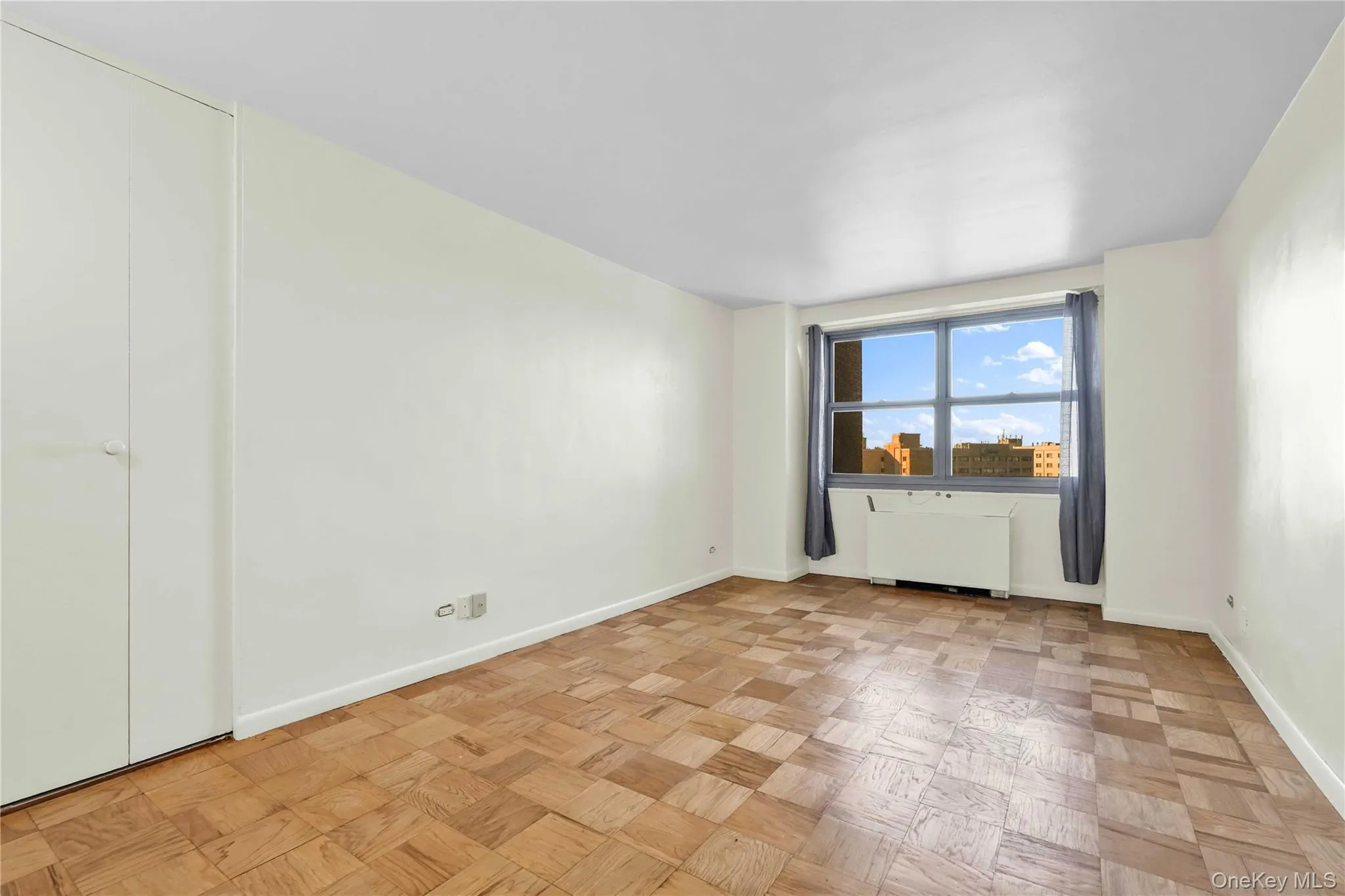 Empty room featuring baseboards and radiator heating unit Empty room featuring baseboards and radiator heating unit