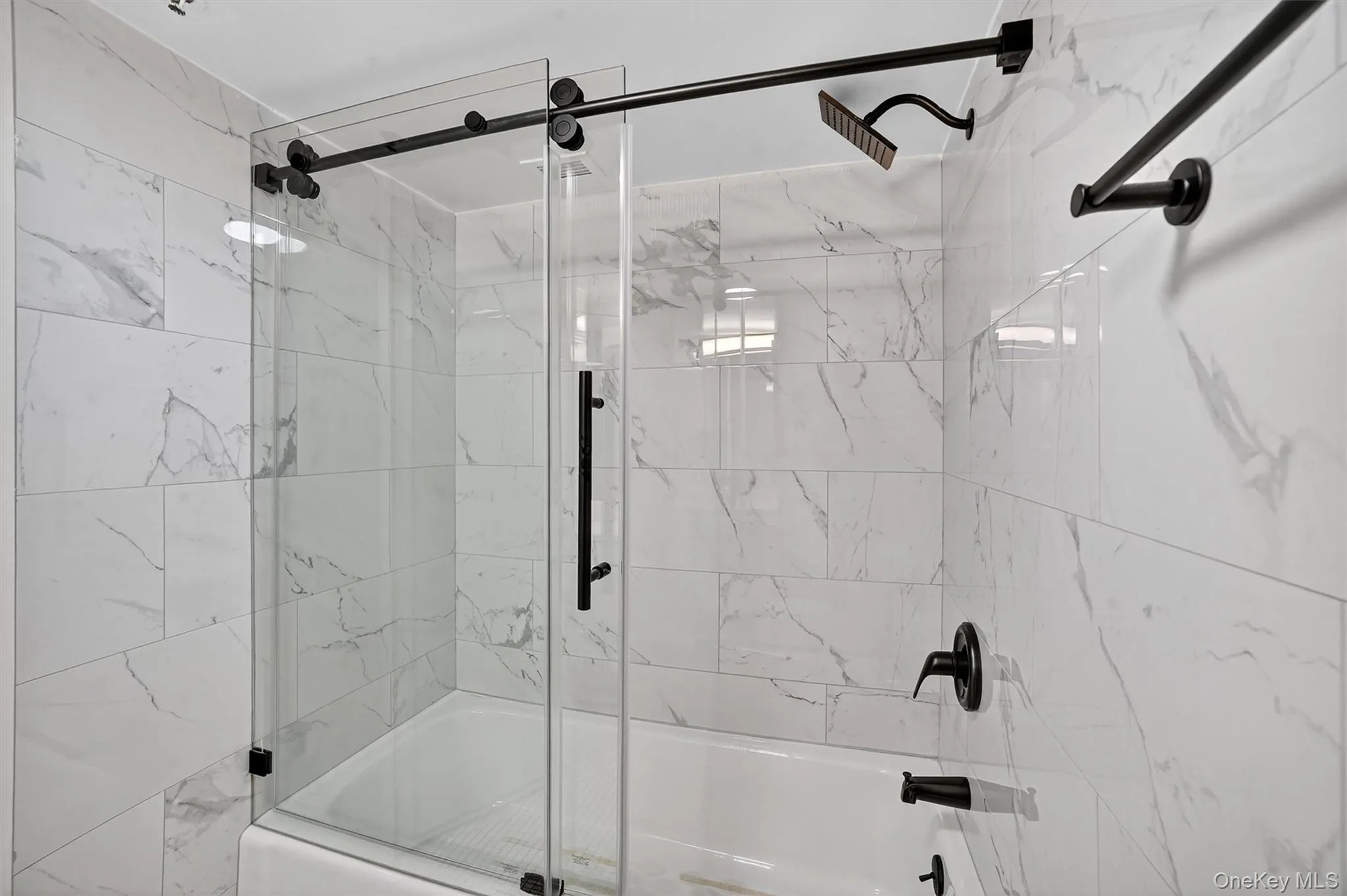 Bathroom featuring combined bath / shower with glass door Bathroom featuring combined bath / shower with glass door