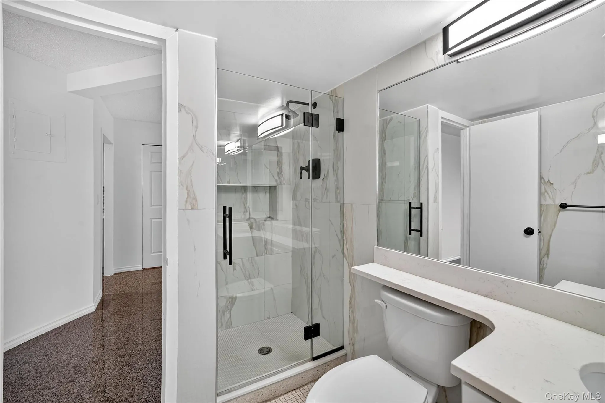 Full bathroom featuring vanity and a marble finish shower Full bathroom featuring vanity and a marble finish shower