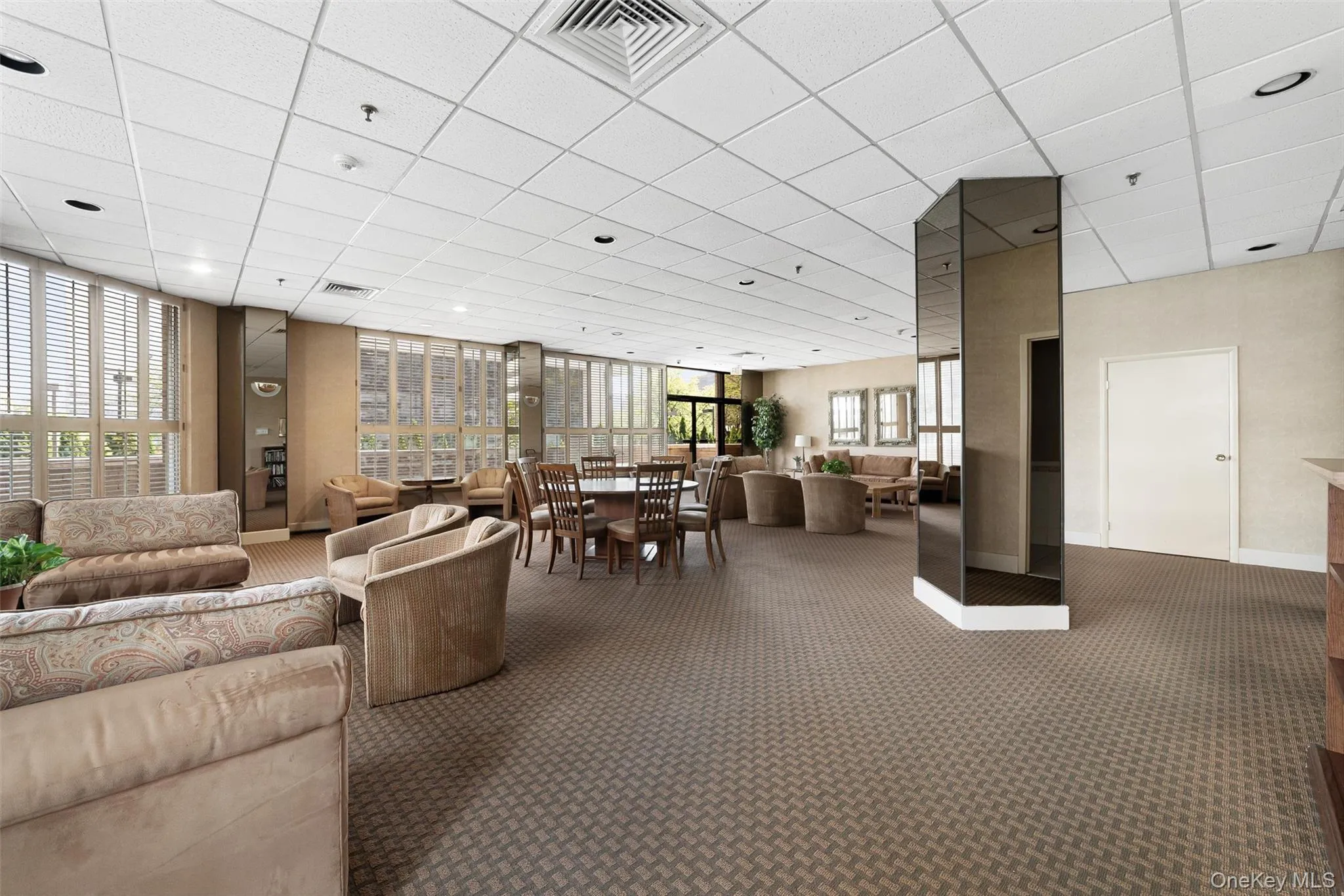 Community lobby featuring a paneled ceiling Community lobby featuring a paneled ceiling