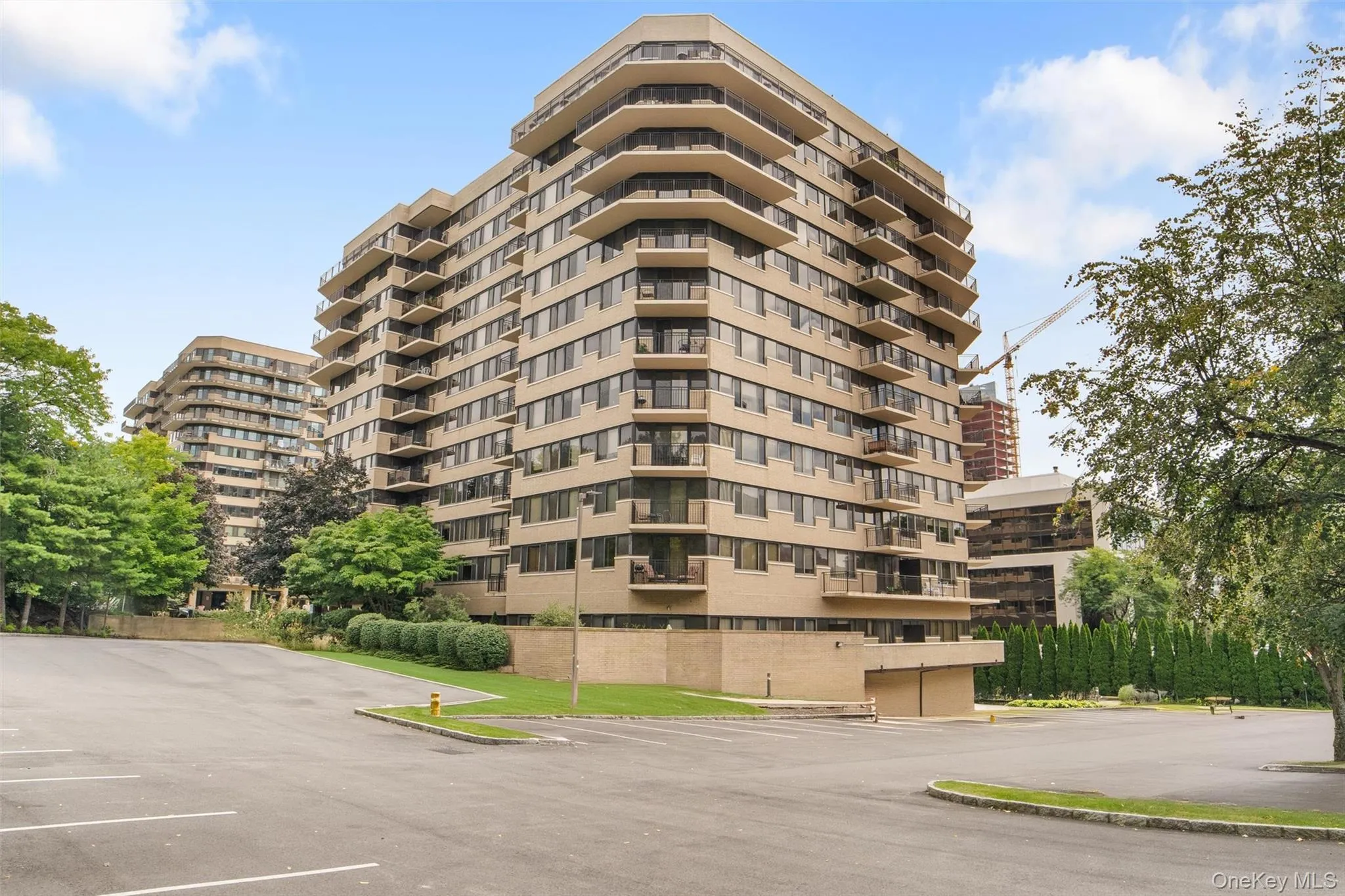 View of apartment building / complex with uncovered parking View of apartment building / complex with uncovered parking