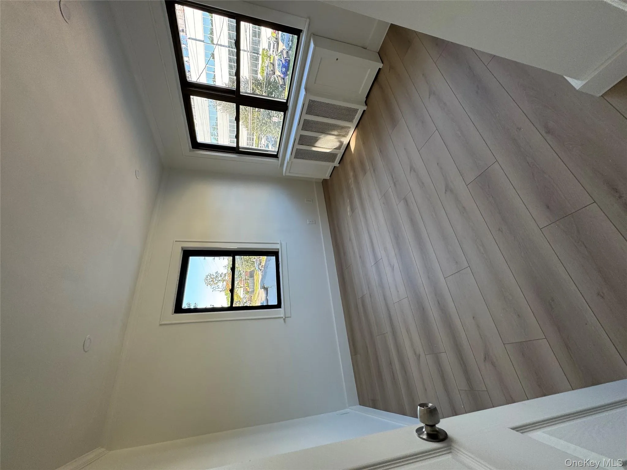 Spare room featuring light wood-type flooring and crown molding Spare room featuring light wood-type flooring and crown molding
