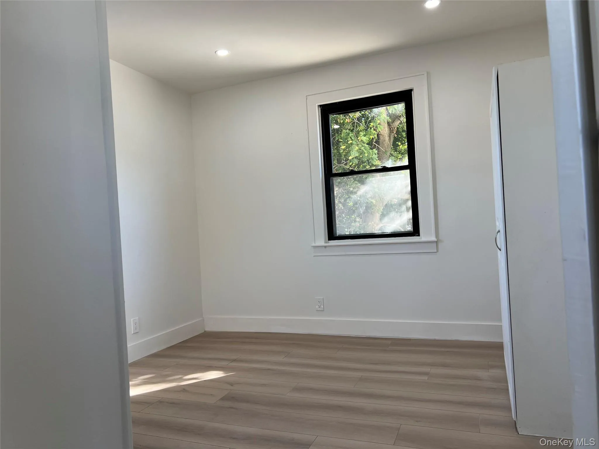 Spare room with light wood-style flooring and recessed lighting Spare room with light wood-style flooring and recessed lighting