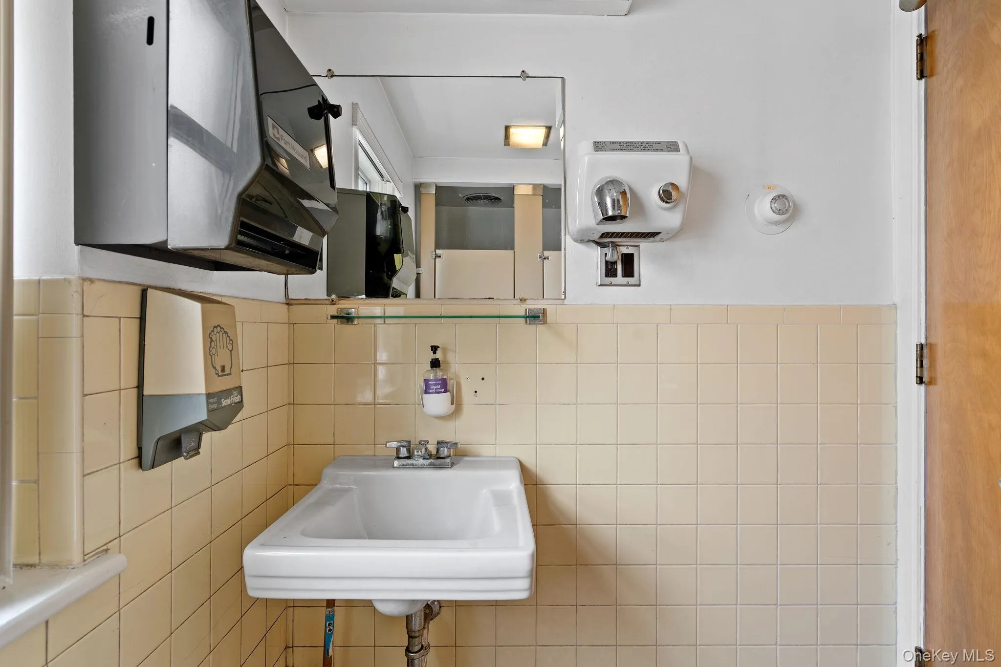 Bathroom with a sink and tile walls Bathroom with a sink and tile walls