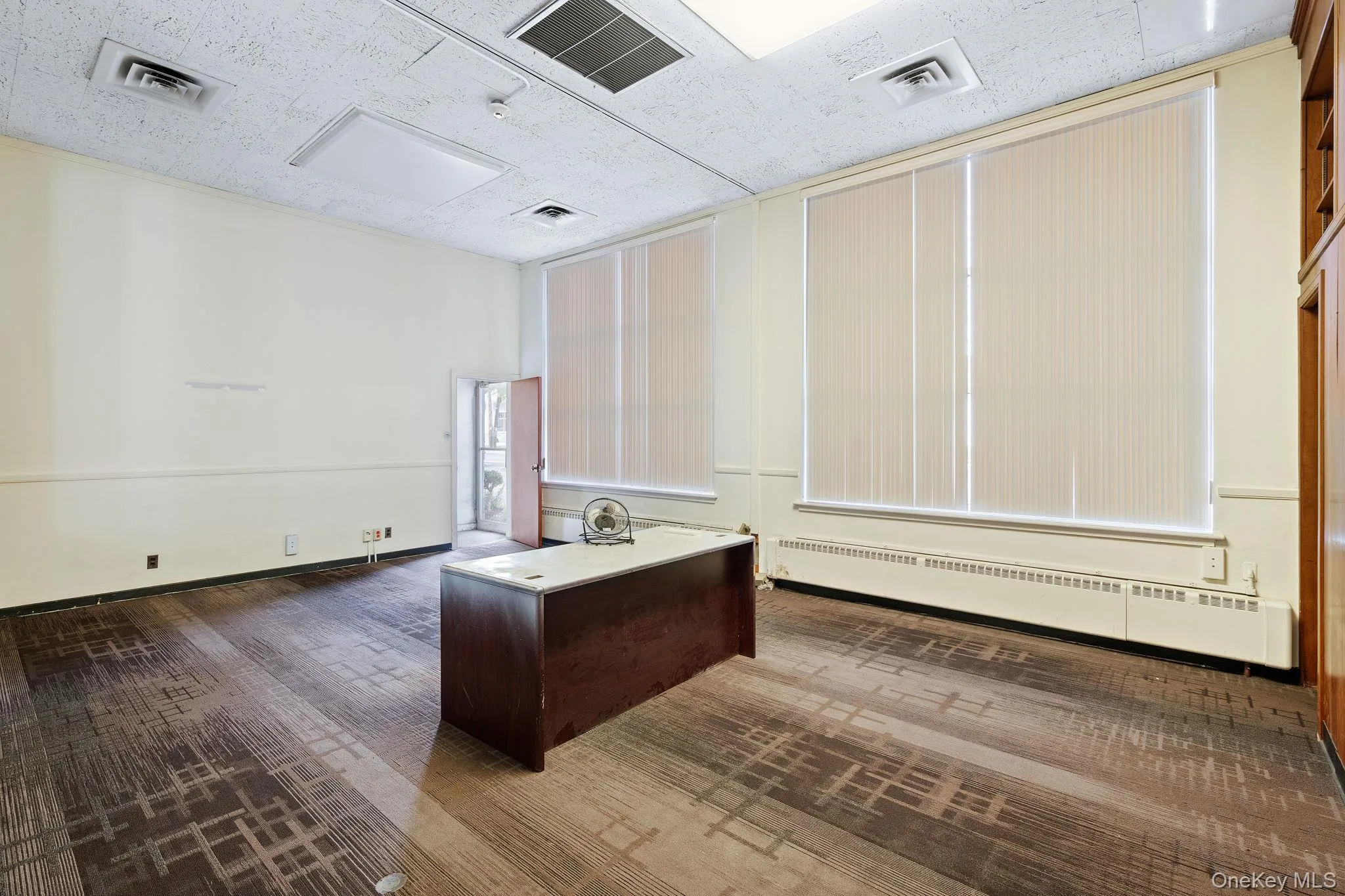 Unfurnished office featuring a baseboard heating unit Unfurnished office featuring a baseboard heating unit