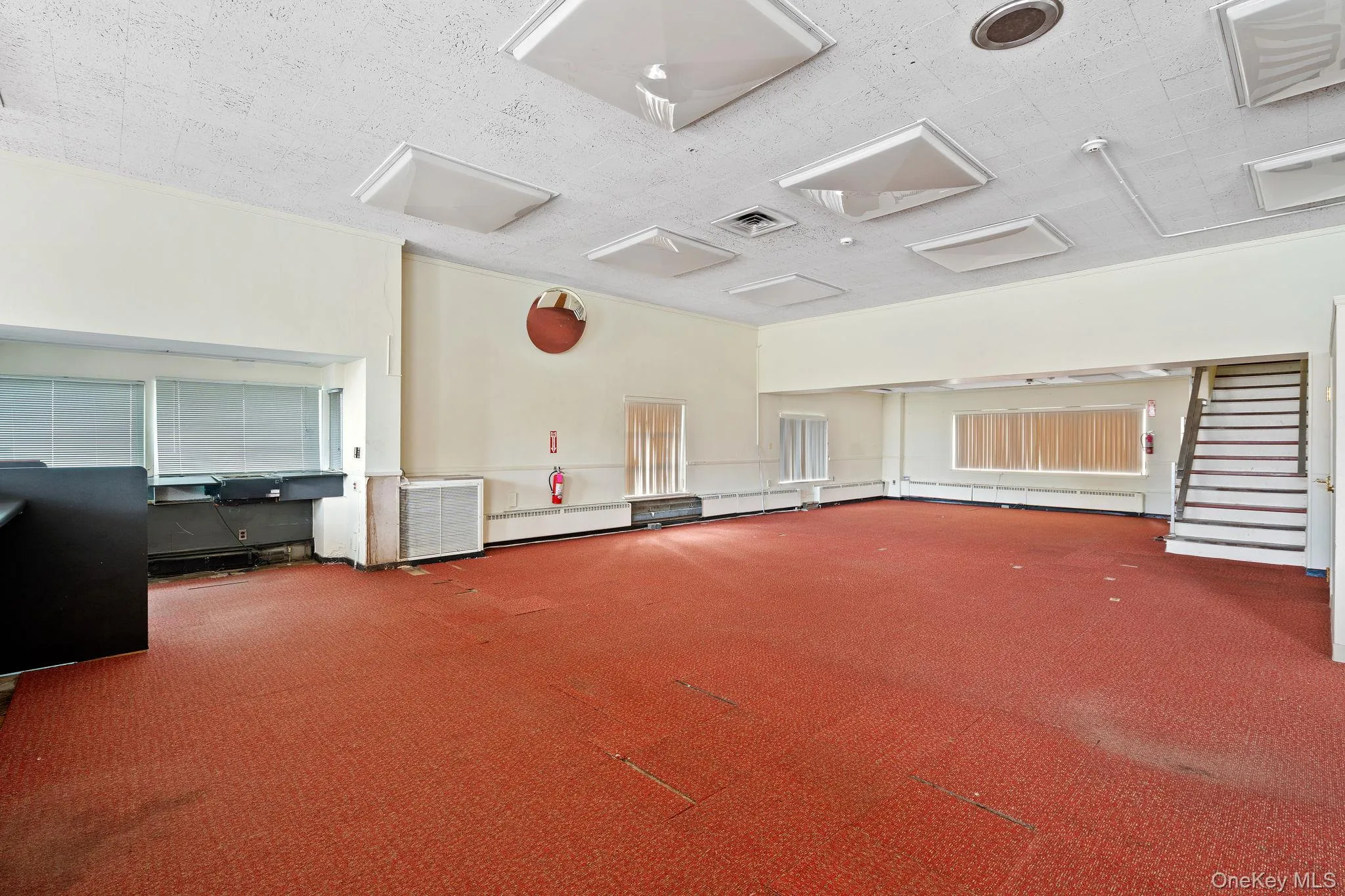 Misc room with a textured ceiling, stairway, and attic access Misc room with a textured ceiling, stairway, and attic access