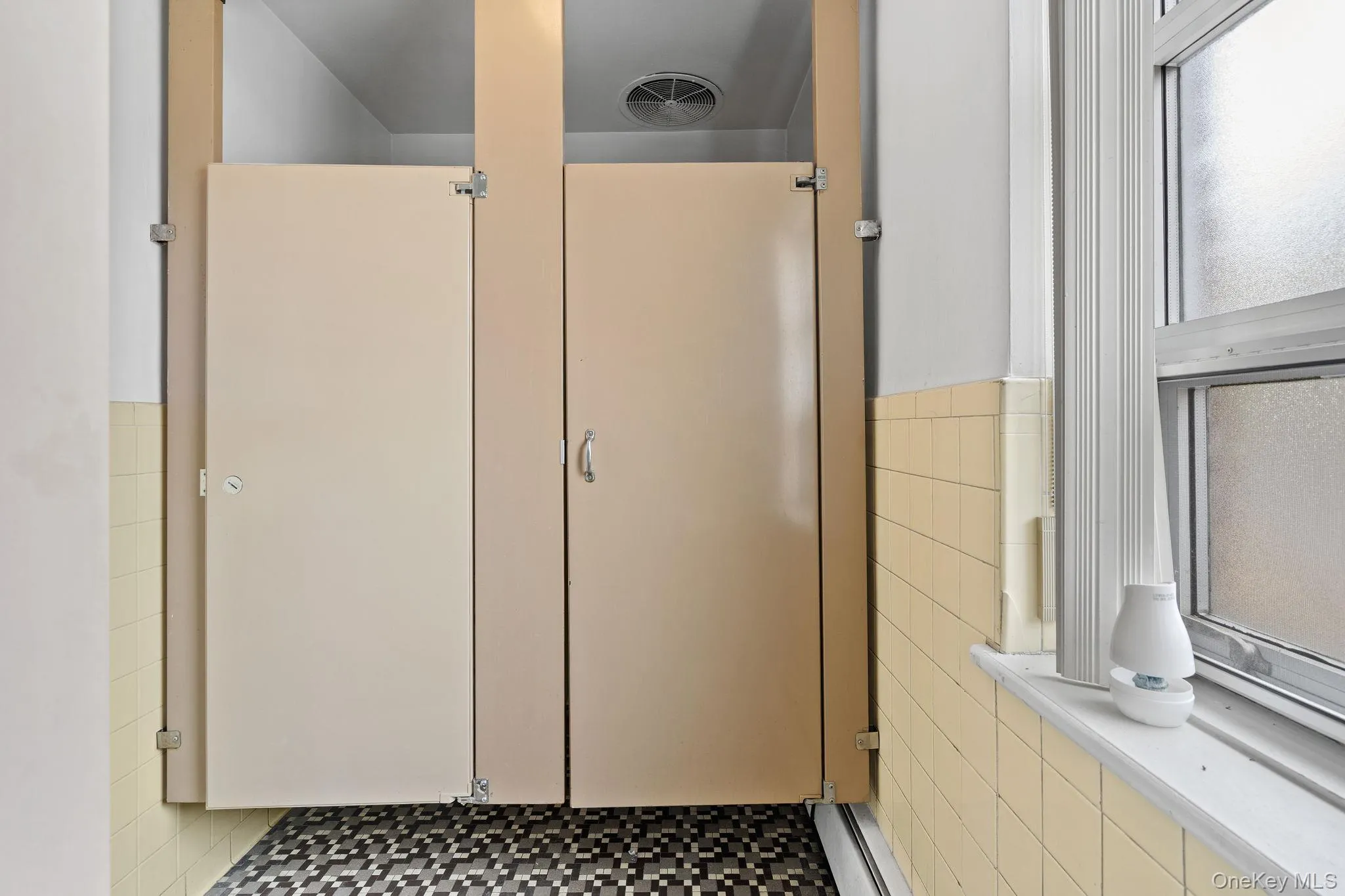 Bathroom with tile walls and a wainscoted wall Bathroom with tile walls and a wainscoted wall