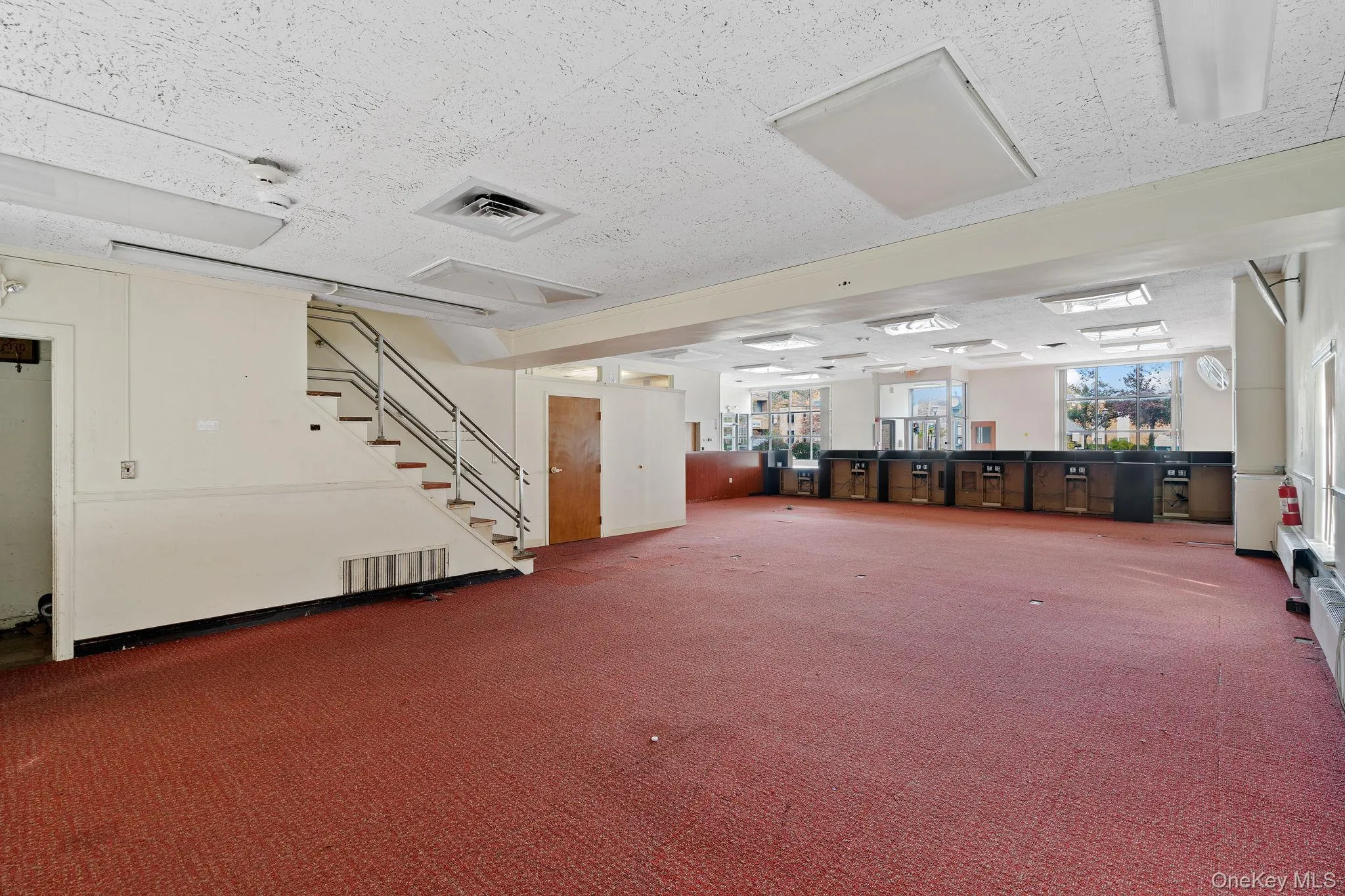 Below grade area with stairway and carpet flooring Below grade area with stairway and carpet flooring