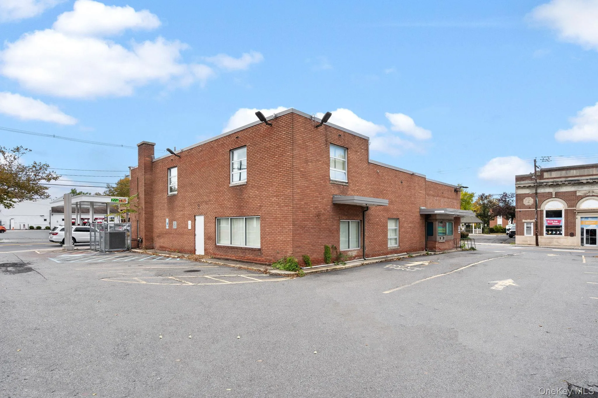 View of building exterior with uncovered parking View of building exterior with uncovered parking