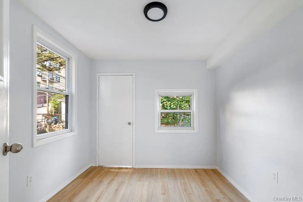 Unfurnished room with plenty of natural light and light wood-type flooring Unfurnished room with plenty of natural light and light wood-type flooring