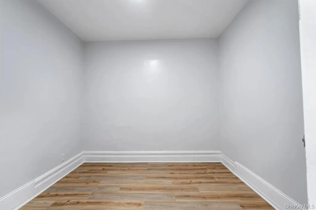Unfurnished room with light wood-style flooring and baseboards Unfurnished room with light wood-style flooring and baseboards