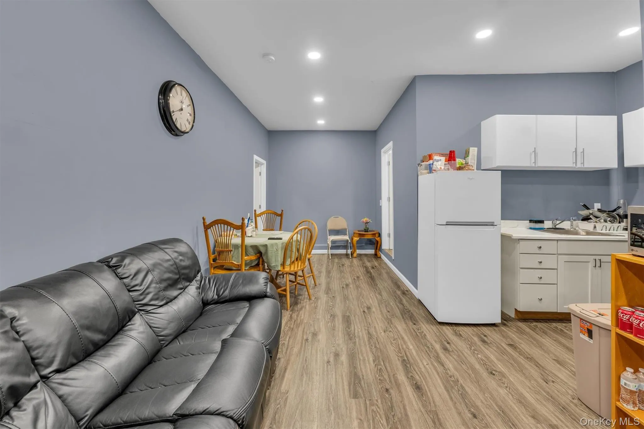 Living area featuring light wood-style flooring and recessed lighting Living area featuring light wood-style flooring and recessed lighting