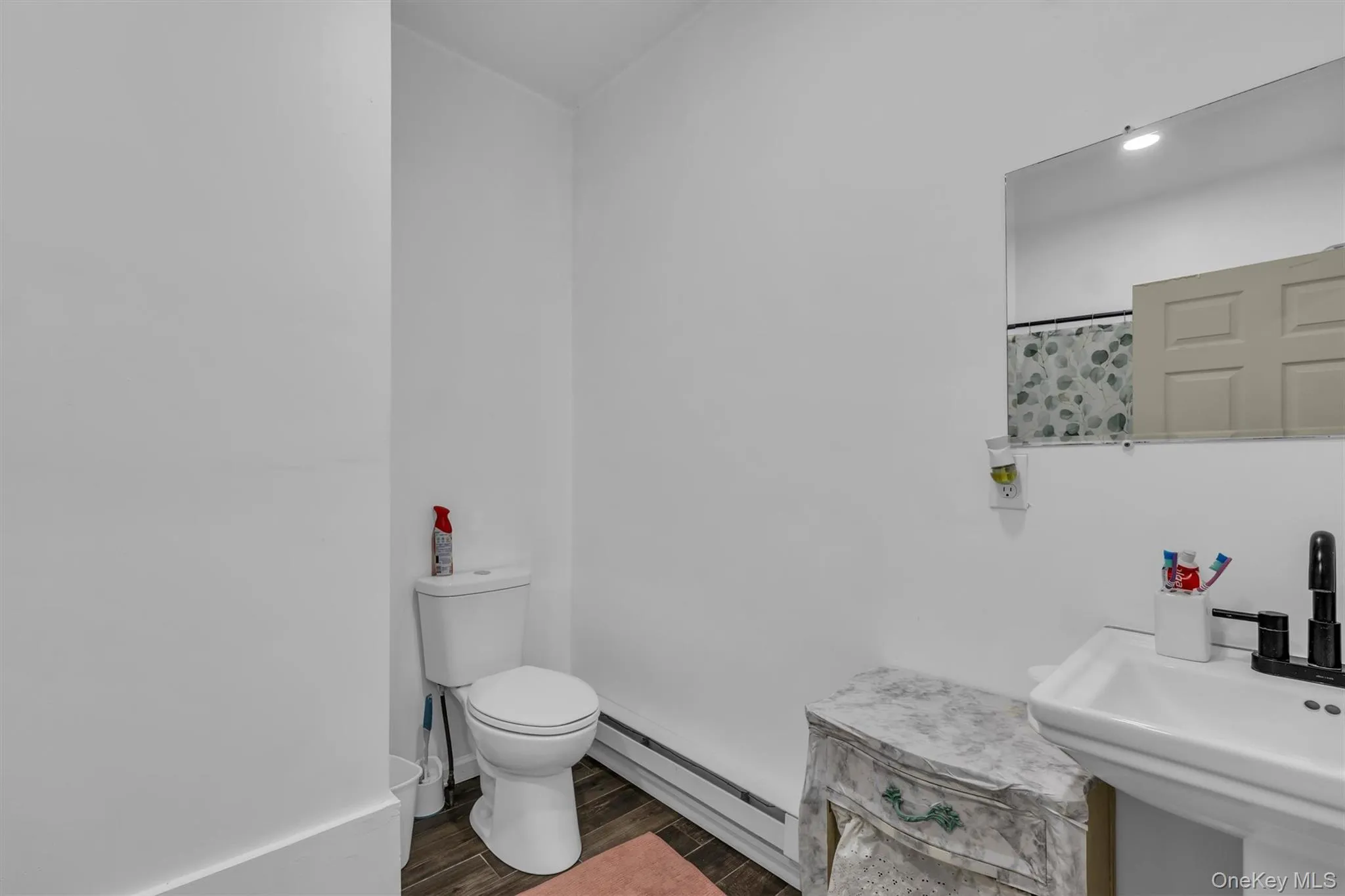 Bathroom with a baseboard heating unit, wood finish floors, and recessed lighting Bathroom with a baseboard heating unit, wood finish floors, and recessed lighting