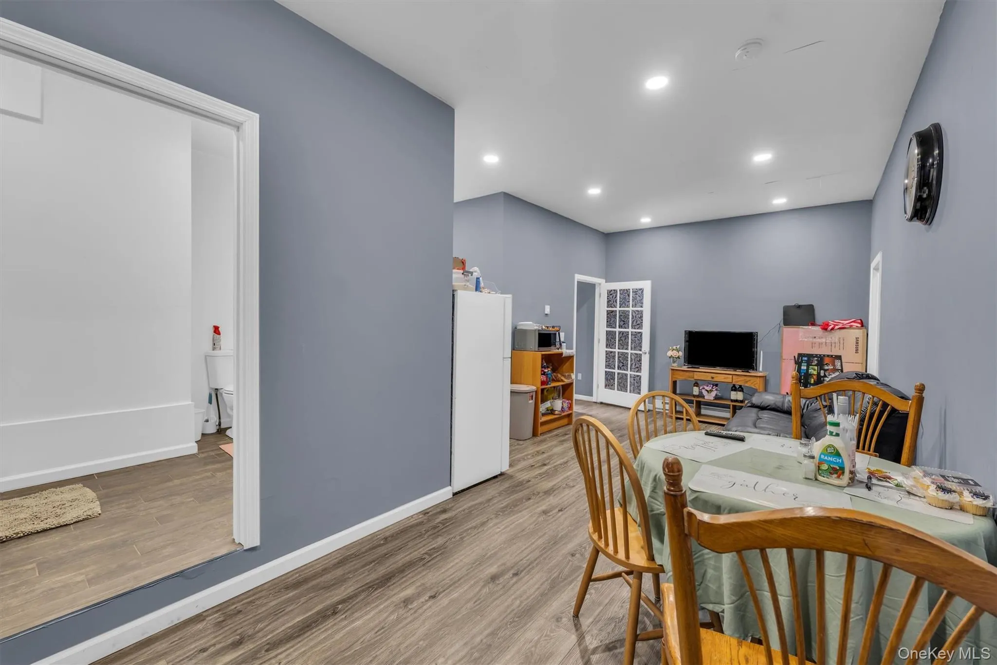 Dining area with light wood-style floors and recessed lighting Dining area with light wood-style floors and recessed lighting