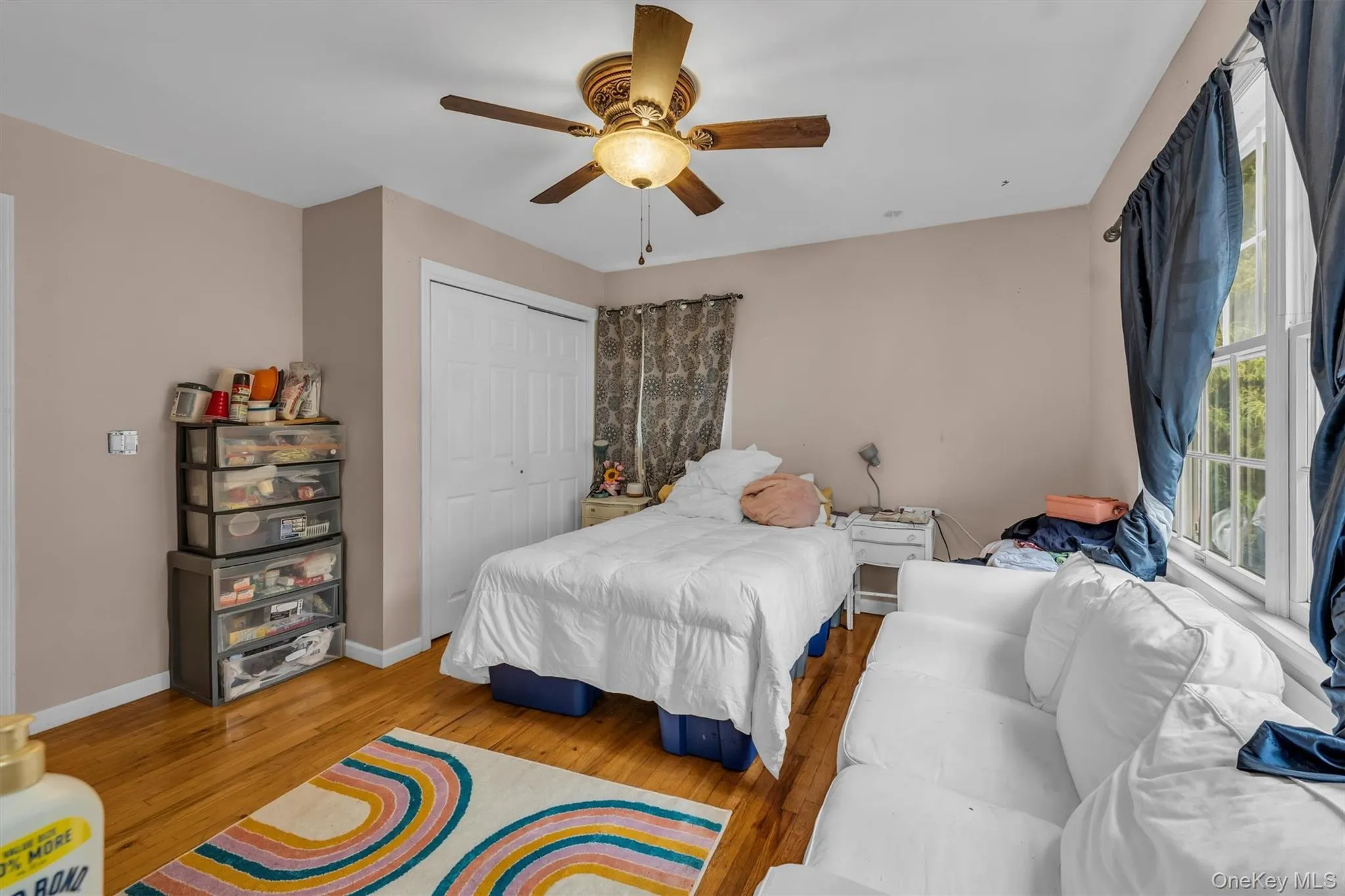 Bedroom featuring wood finished floors, a closet, and ceiling fan Bedroom featuring wood finished floors, a closet, and ceiling fan